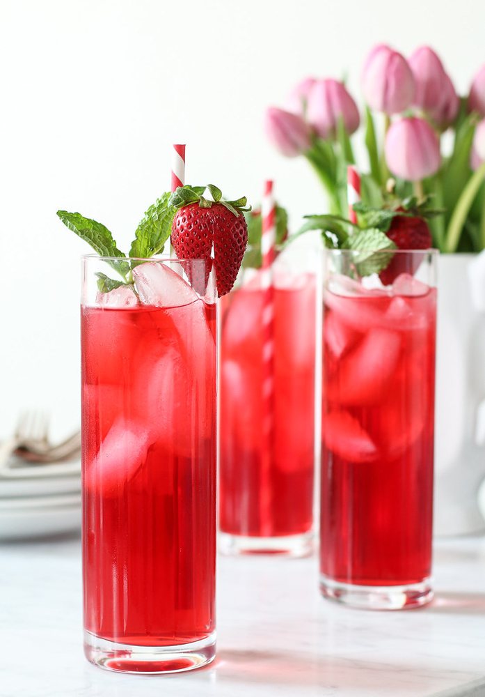 Hibiscus Iced Tea Cooler with vodka and mint leaves in tall glasses with stra…