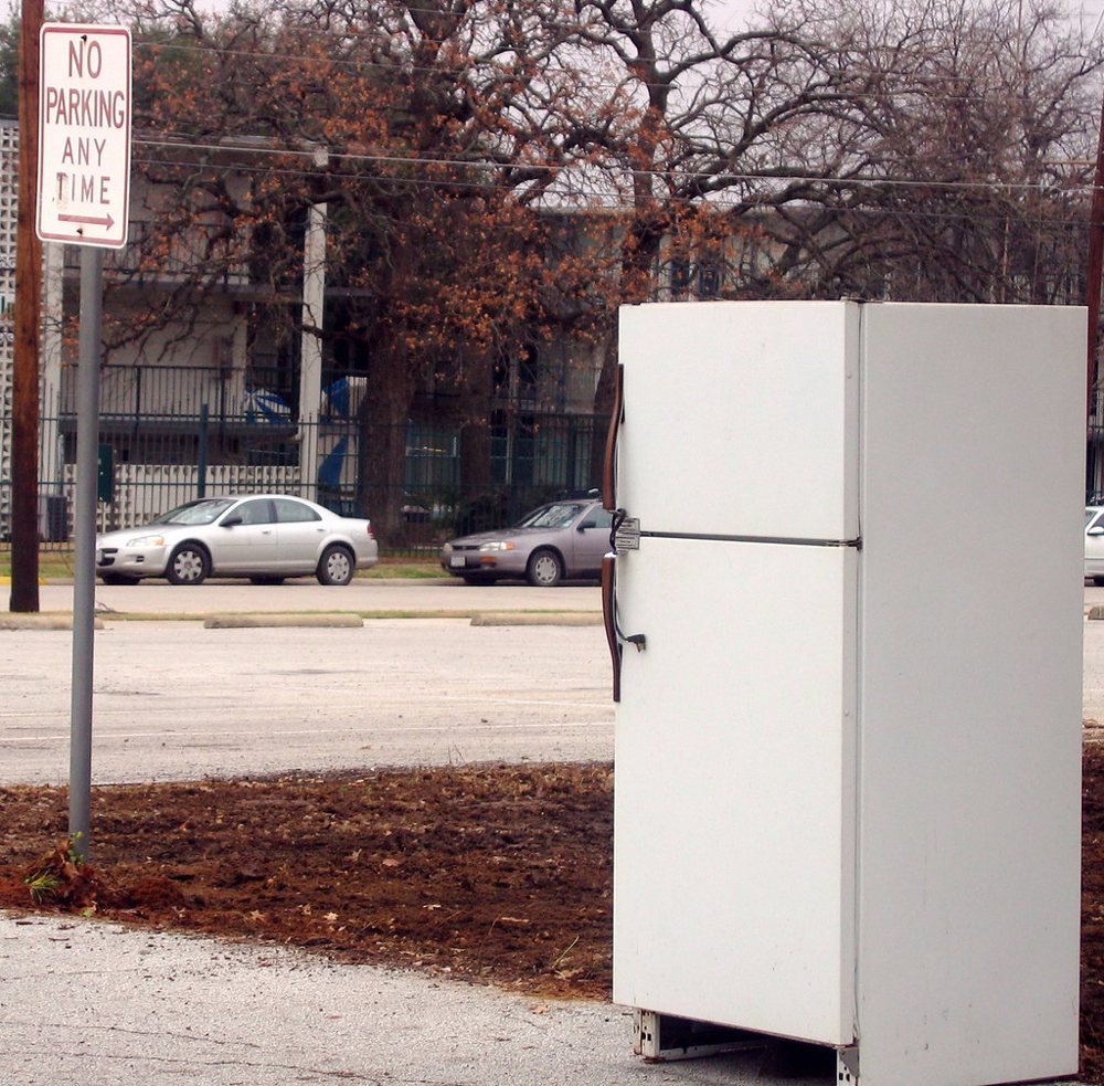 Refrigerator in a parking lot.