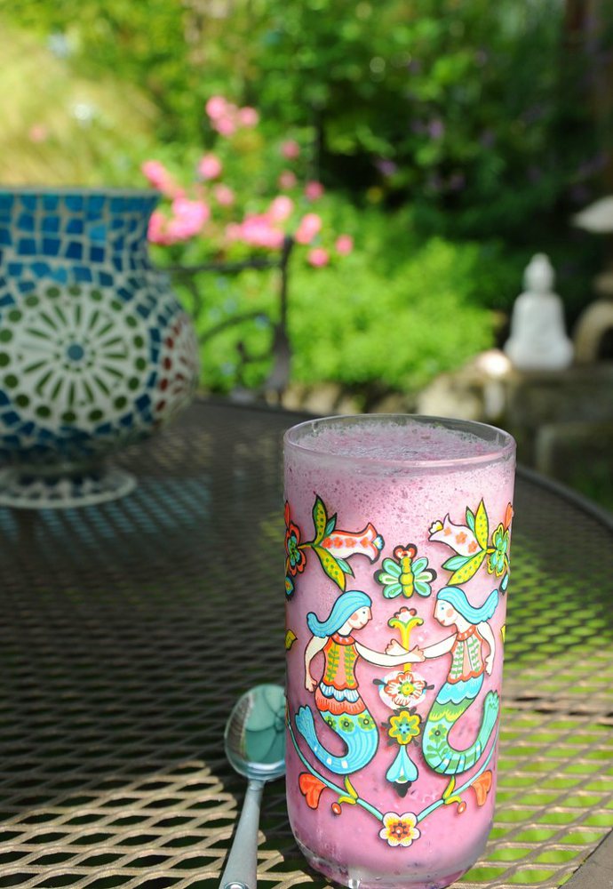 Boysenberry milkshake in a tumbler decorated with two mermaids (World Market)…