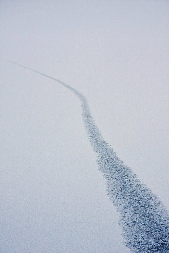 Winding trace of breaking ice on frozen lake